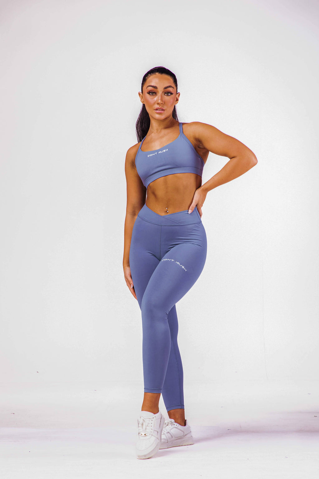 A woman wearing an eccentric blue coloured sports bra with a pair of matching leggings
