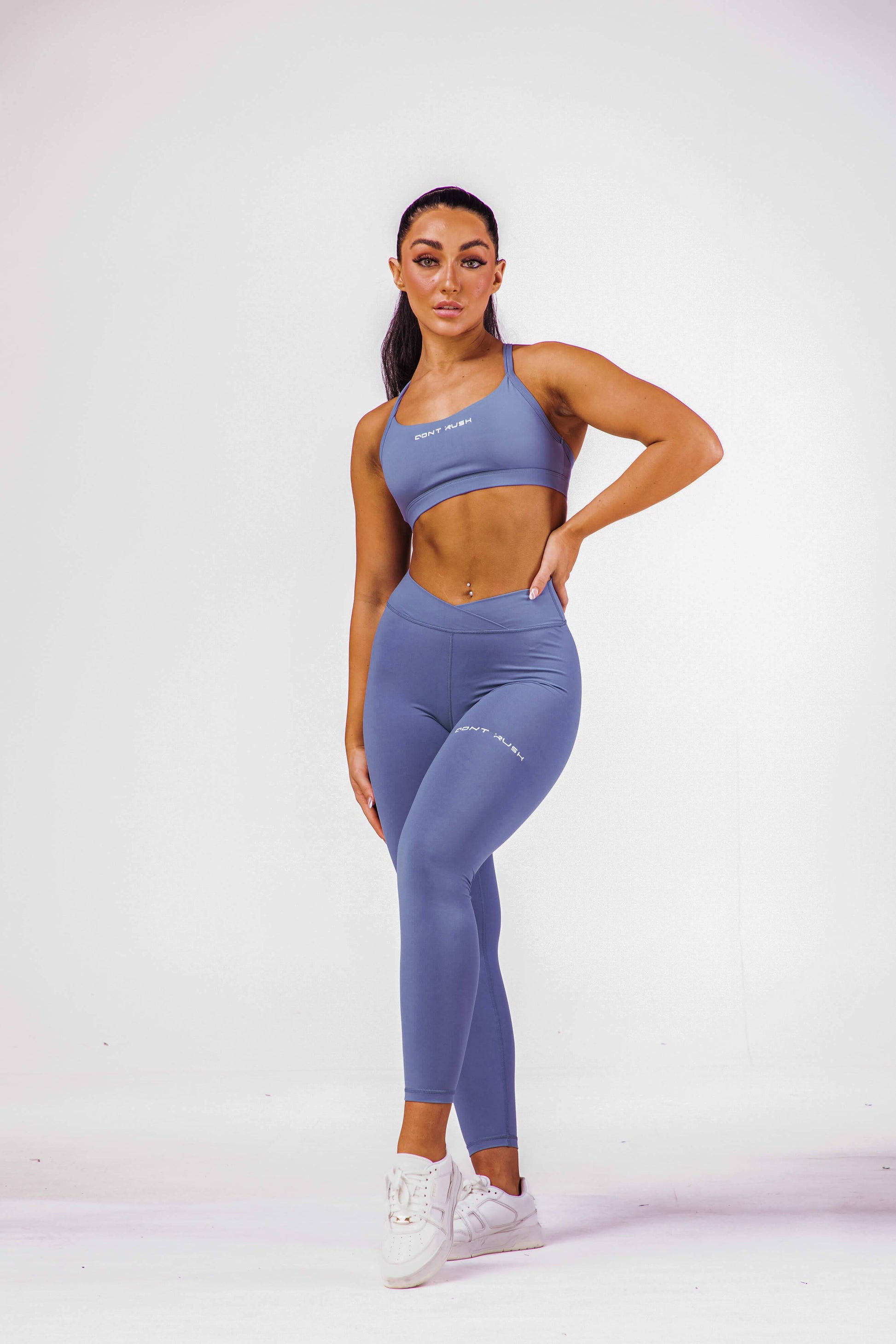 A woman wearing an eccentric blue coloured sports bra with a pair of matching leggings